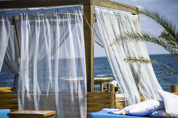 Beach bed and sunloungers in a beach