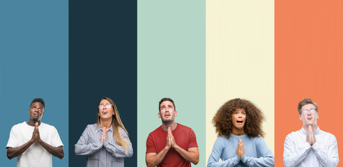 Group of people over vintage colors background begging and praying with hands together with hope expression on face very emotional and worried. Asking for forgiveness. Religion concept.