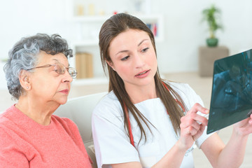 female doctor looking at xray with senio patient