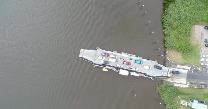 Off-boarding cars from cargo vehicle ferry on Hawkesbury river around Wiseman ferry town in NSW of Australia. Local transportation across the river.
