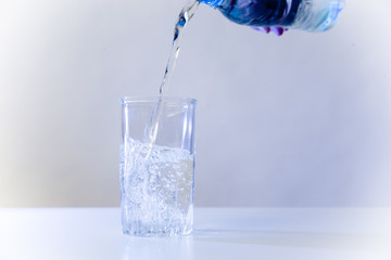 Glass of pure water on a white kitchen table