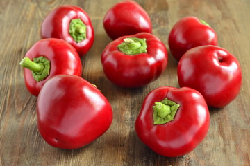 Sweet red pepper on the wooden background,  rotunda