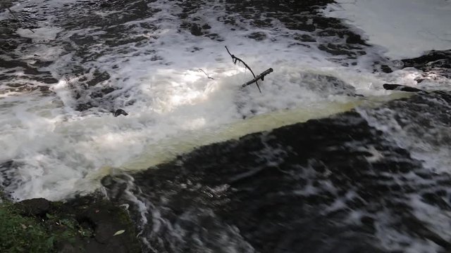 A small waterfall on the Sestra river in Klin. Close up of water and stone without grass and trees.