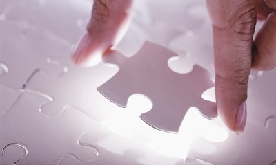 Fitting last white puzzle piece. Concept image of building and