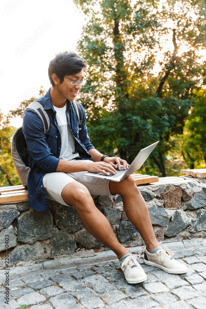 Canvas Prints full length image of happy asian male student in eyeglasses