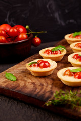 Fototapeta na wymiar Mini tarts with cherry tomatoes with mozzarella cheese