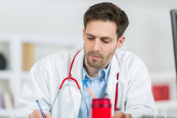 handsome young doctor at work in his office