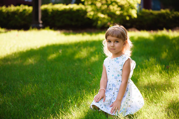 Beautiful little young girl outdoorin a park.