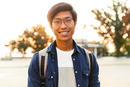Picture of Joyful asian male student in eyeglasses
