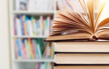 Old stacked books on background