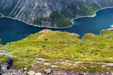 Fototapeta na wymiar A photographer taking picture of lake Ringedalsvatnet on the way to Trolltunga, Norway.