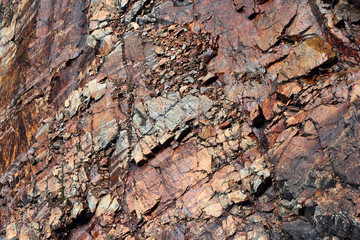 Red crumbling rocks, natural stone background
