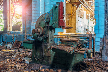 Fototapeta premium Old industrial machine tool in workshop. Rusty metal equipment in abandoned factory