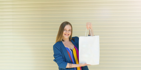 lifestyle concept. woman holding white craft package with empty space for your logo or design, shopping bag with handles.