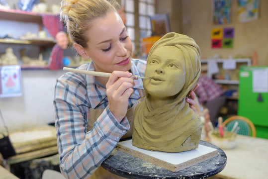 Female artist working on sculpture