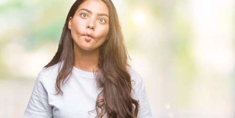 Young beautiful arab woman over isolated background making fish face with lips, crazy and comical gesture. Funny expression. - obrazy, fototapety, plakaty