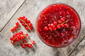 Cranberry sauce in bowl for Thanksgiving dinner on wooden table. Top view