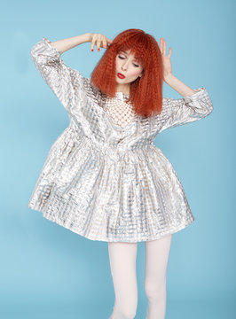 Red haired model posing in vintage dress