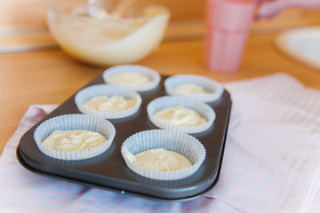 a concept of baking sweet cupcakes and muffins at home