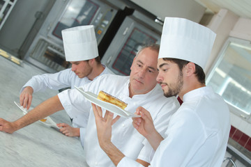 focused chef preparing a cake in the restaurant kitchen
