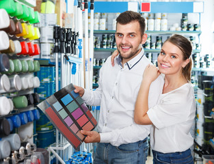 Couple using palette scheme in store