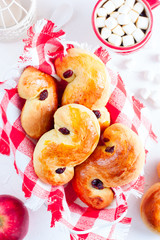 Traditional swedish buns in christmas setting. A saffron bun, in Swedish lussebulle or lussekatt.