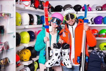  man and woman posing in full skiing gear