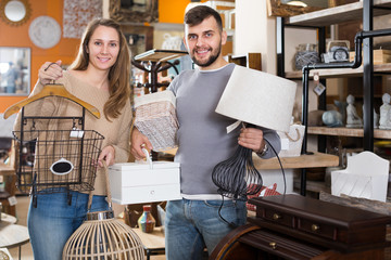  couple standing with purchases in furnishings store