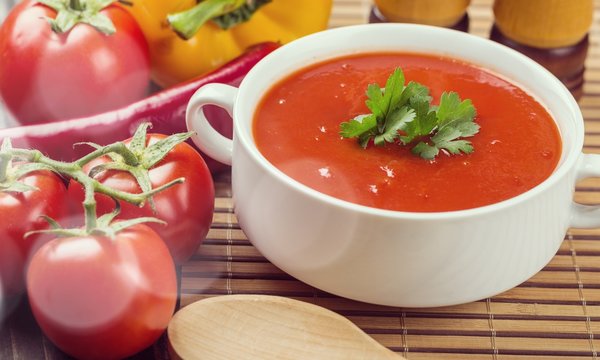 Bowl of gazpacho or tomato soup with ingredients