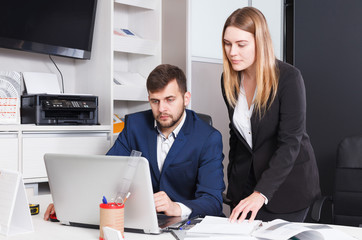 Successful salespeople working on laptop
