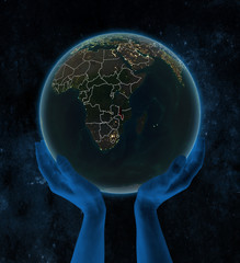 Malawi on night Earth in hands