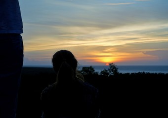 Unknown woman looking at the sunset