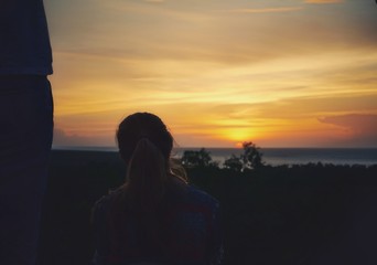 Fototapeta premium Unknown woman looking at the sunset