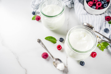 Two portion of yogurt with berries