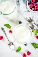 Two portion of yogurt with berries