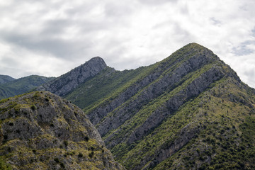 Mountains with white clouds on a blue sky background