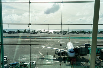 A airplane at an airport through a window on the run way