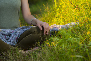 mudra of hand  young woman are folded in a special way into a yoga. Behind a strongly blurred background