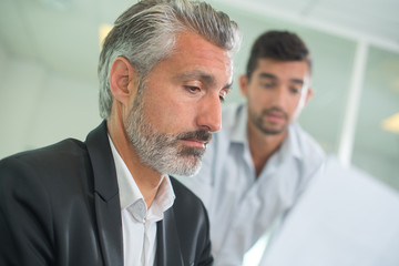 worried businessmen sitting in office