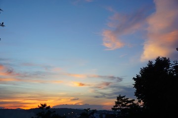 Fototapeta na wymiar Sunset and dramatic sky with trees