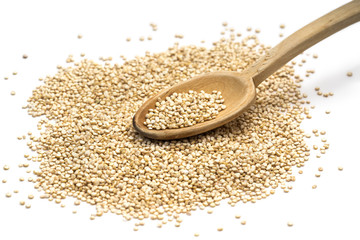 Quinoa seeds on a wooden spoon seen obliquely from above and isolated on white background