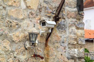 CCTV security camera on the ancient stone wall