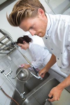 chefs washing utensils