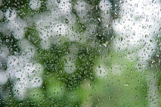 raindrop on glass window close up use as background in rainy season.