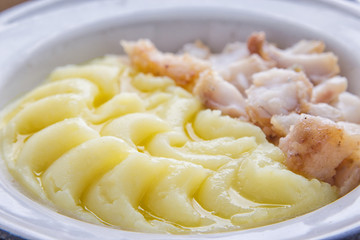 Tasty meal with fried fish fillet and mashed potatoes.