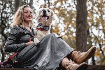 They best friends.Portrait of beautiful smiling woman with dog in the park.