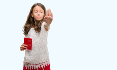 Obraz premium Brunette hispanic girl holding passport of Switzerland with open hand doing stop sign with serious and confident expression, defense gesture