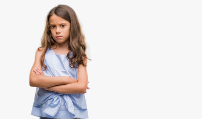 Brunette hispanic girl skeptic and nervous, disapproving expression on face with crossed arms. Negative person.