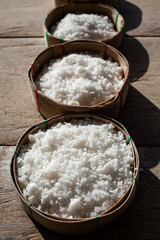 salt in wooden basket on wood table background