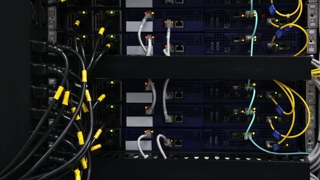 Server front side showing colorful switches and wiring Abstract blurred image for use as a background Close-up
